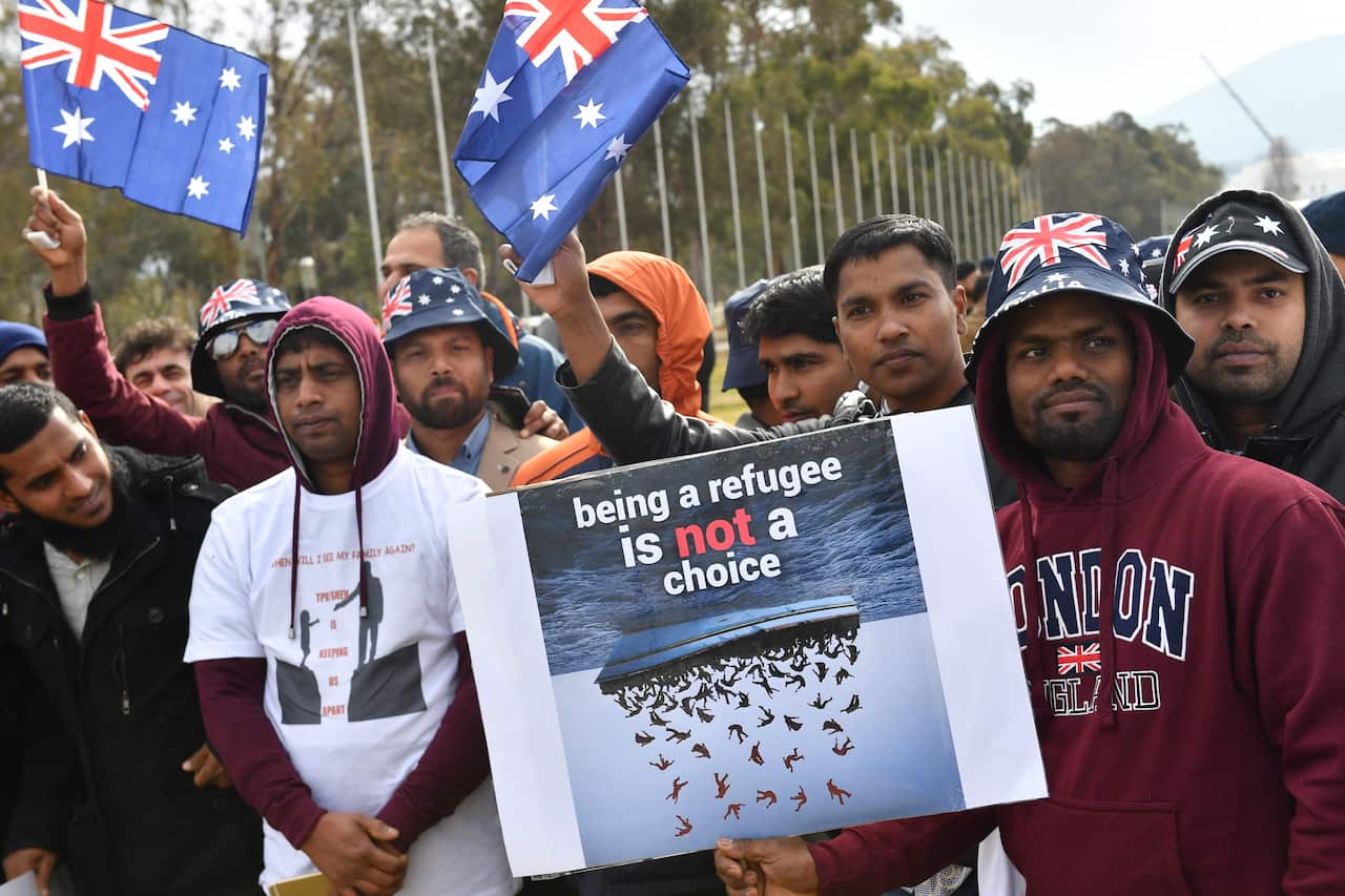 Temporary Protection Visa (TPV) and Safe Haven Enterprise Visa (SHEV) holders are seen as they attend a rally outside Parliament House in Canberra, Monday, 29 July, 2019. (AAP Image/Mick Tsikas) NO ARCHIVING