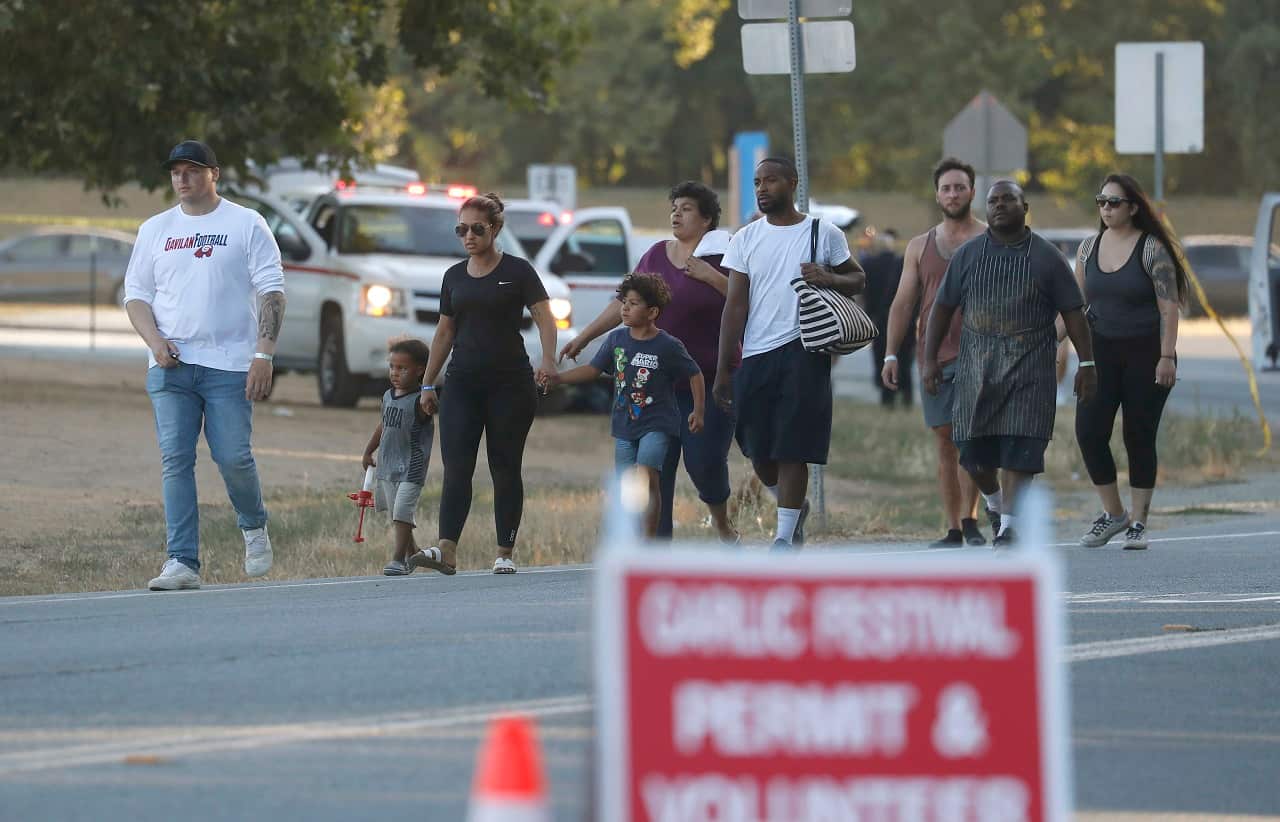 People leave the Gilroy Garlic Festival following a shooting.