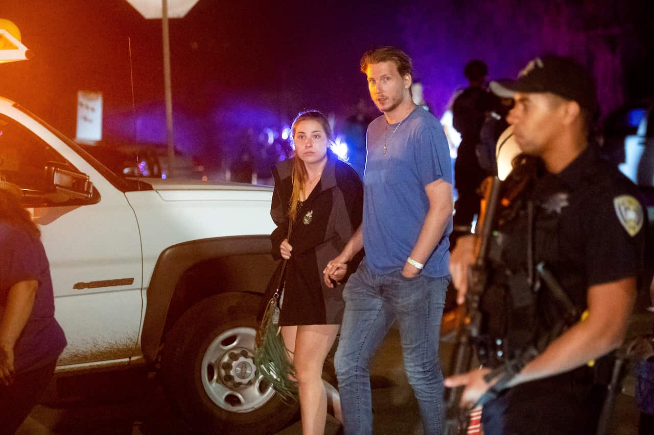 Police officers escort people from Christmas Hill Park following a deadly shooting during the Gilroy Garlic Festival, in Gilroy, Calif., on Sunday, July 28, 2019. (AP Photo/Noah Berger)