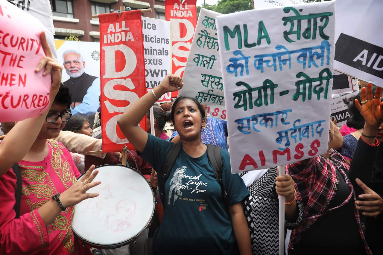 Women activists shout slogans during the protest.