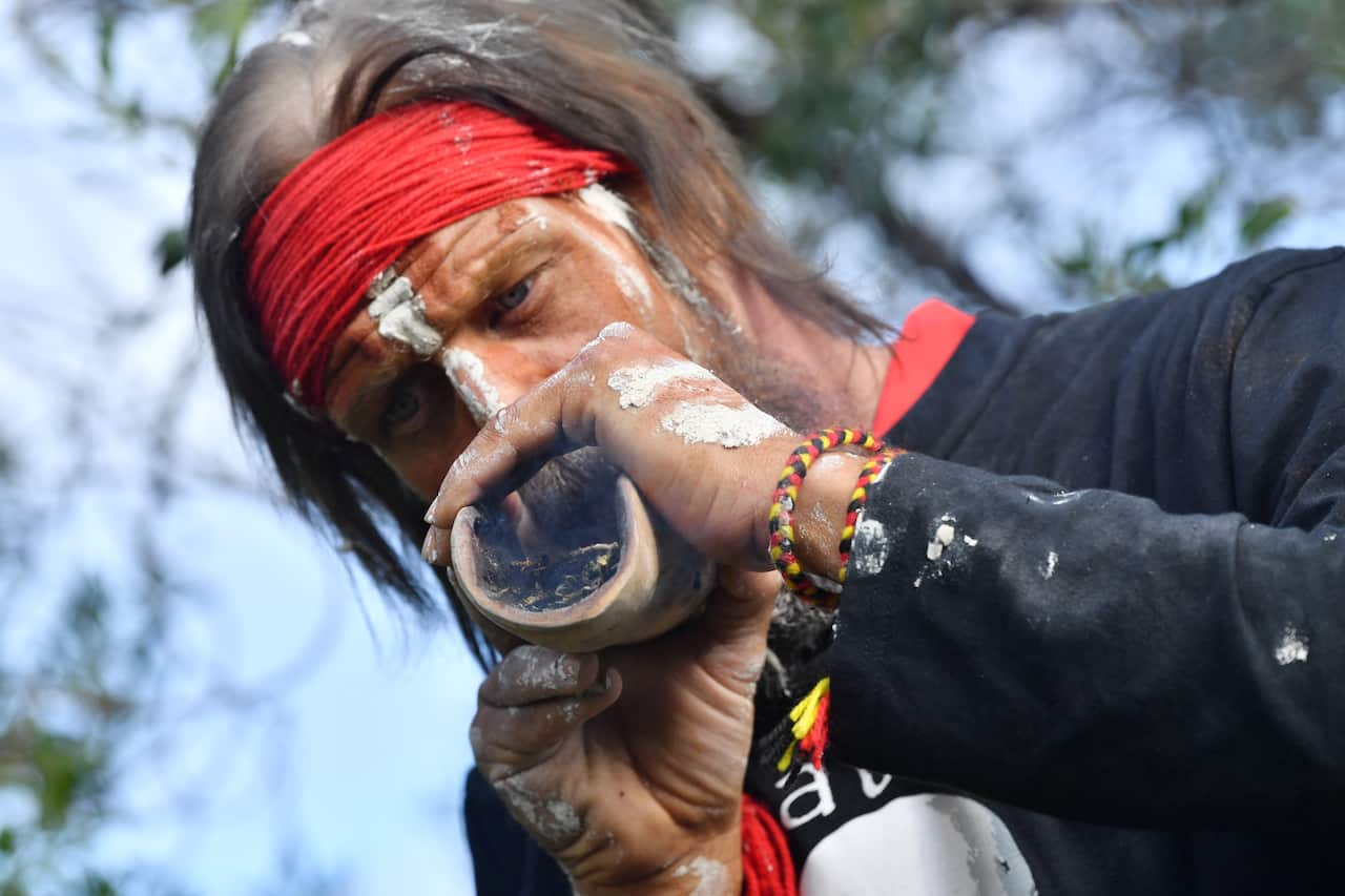 Elder Yuandanarra is seen during a burial ceremony to return of Kaurna Old People at Kingston Park, Adelaide. Thursday.