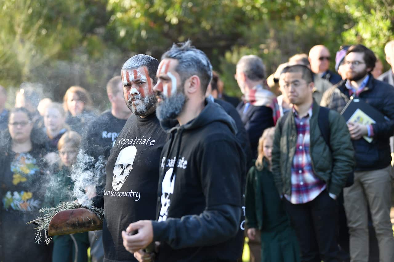 Local Indigenous members are seen during a burial ceremony to return of Kaurna Old People at Kingston Park, Adelaide. 