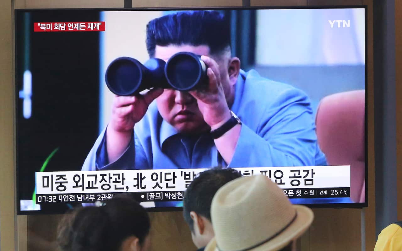 A file photo of people at a Seoul train station watching a TV showing footage of North Korean leader Kim Jong Un.