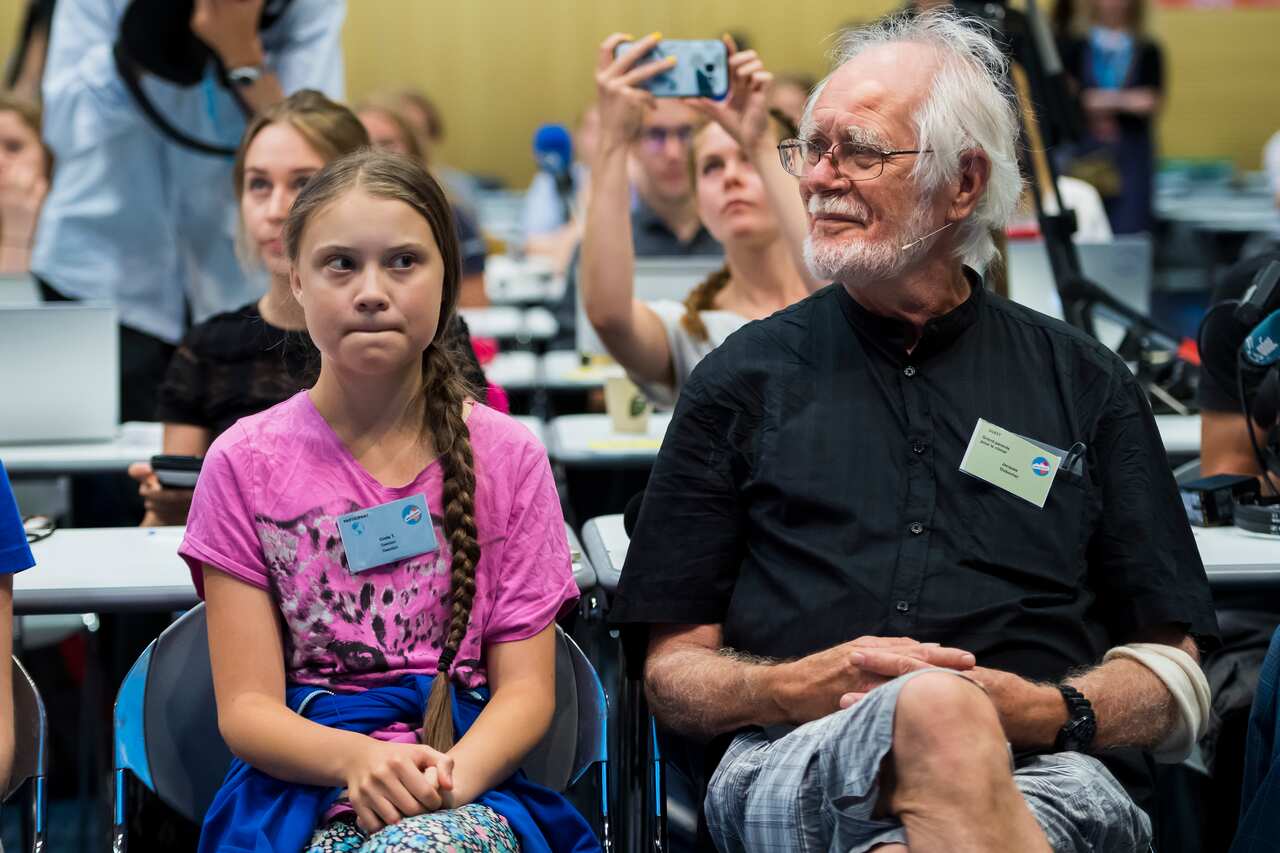 Swedish climate activist Greta Thunberg sits next Jacques Dubochet, Nobel laureate in Chemistry, during a press conference of the 'Fridays For Future Summit'