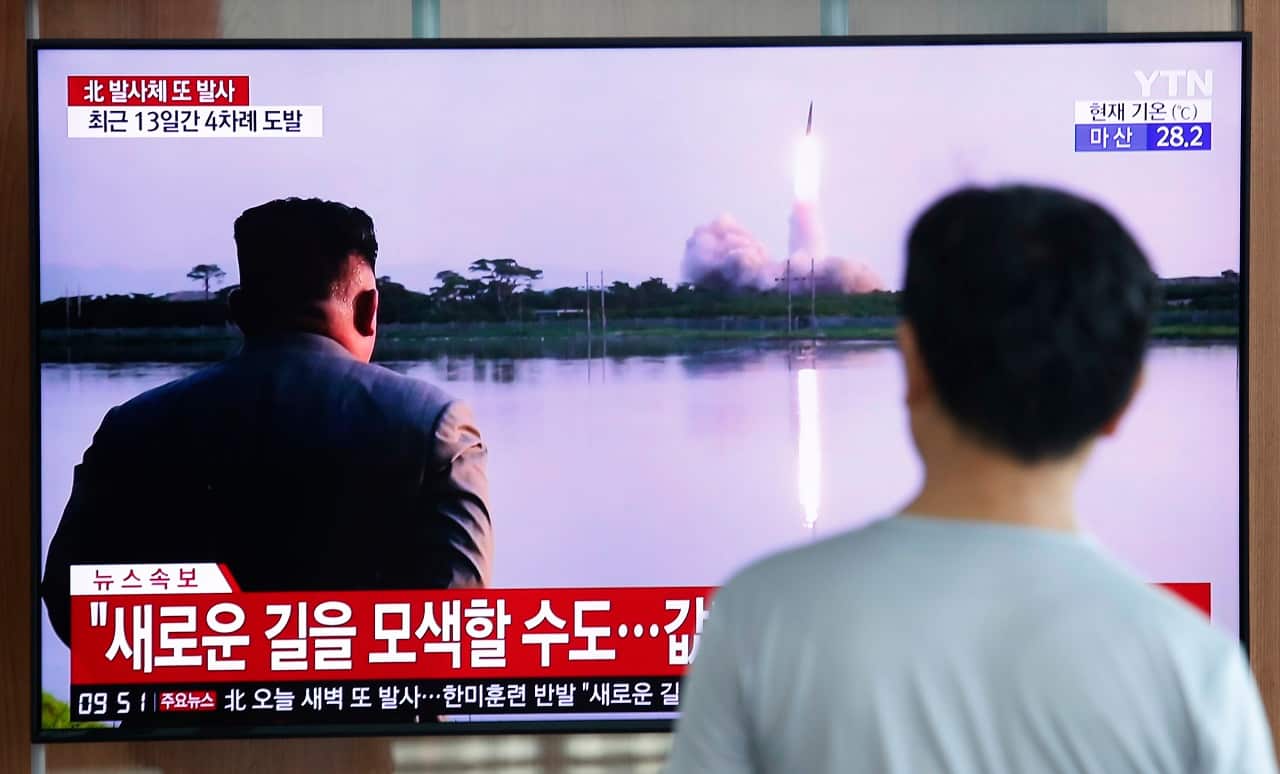 A man watches a TV showing North Korea's missile launch.