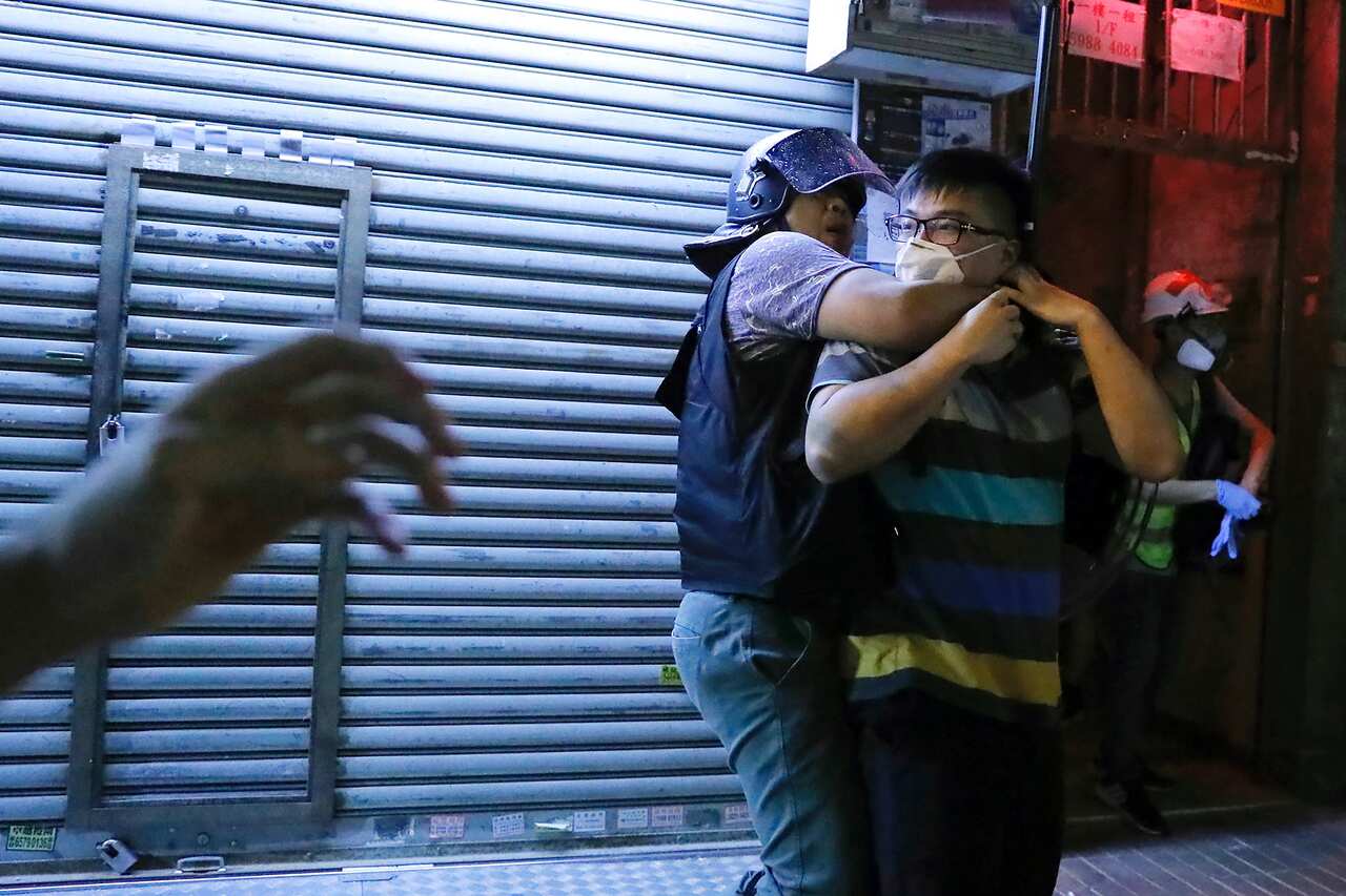 Police arrest a man during a face off at Sham Shui Po district in Hong Kong.