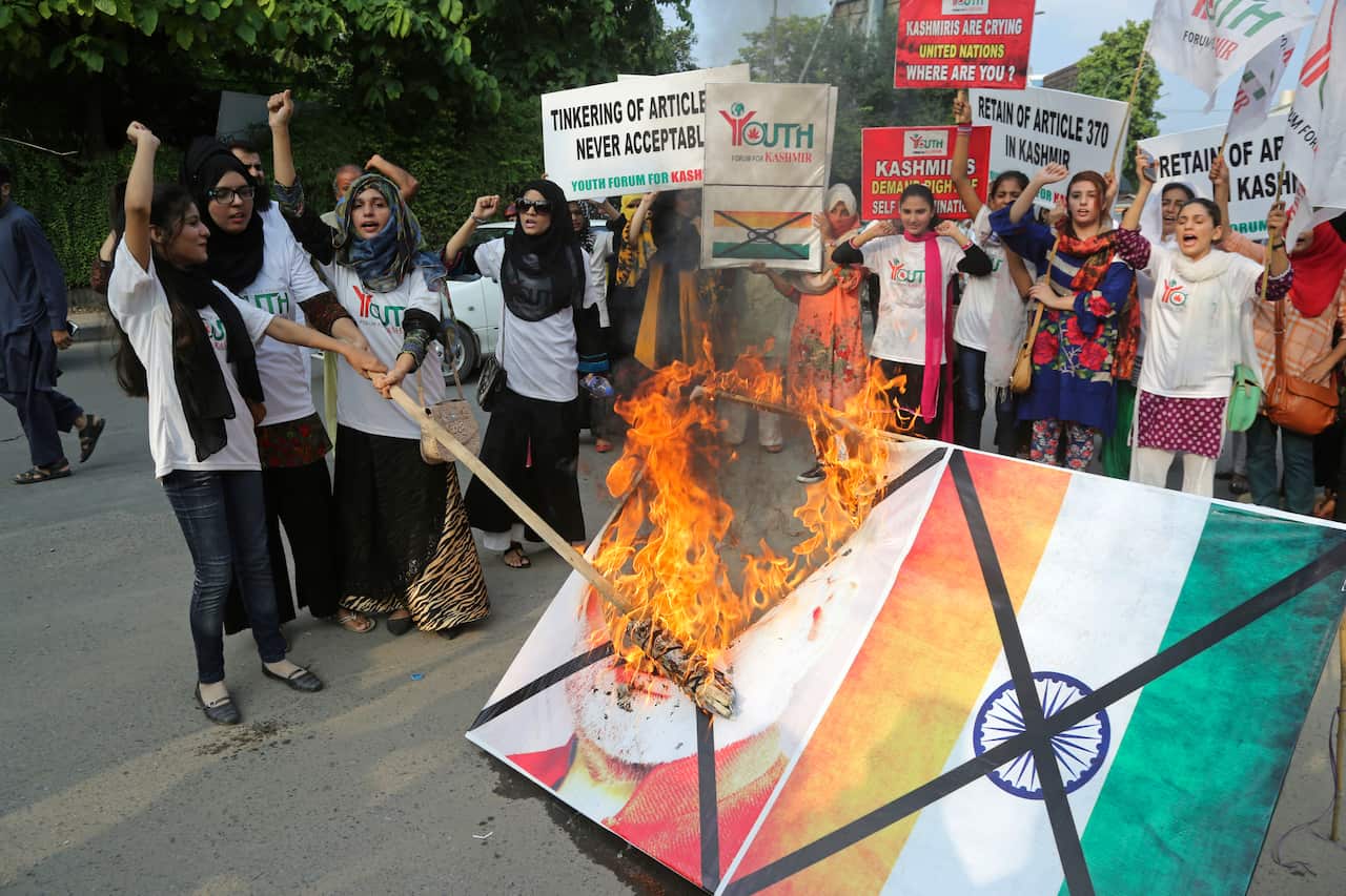 Pakistani students burn a poster of Indian Premier Narendra Modi during an anti-Indian rally in Lahore, Pakistan.