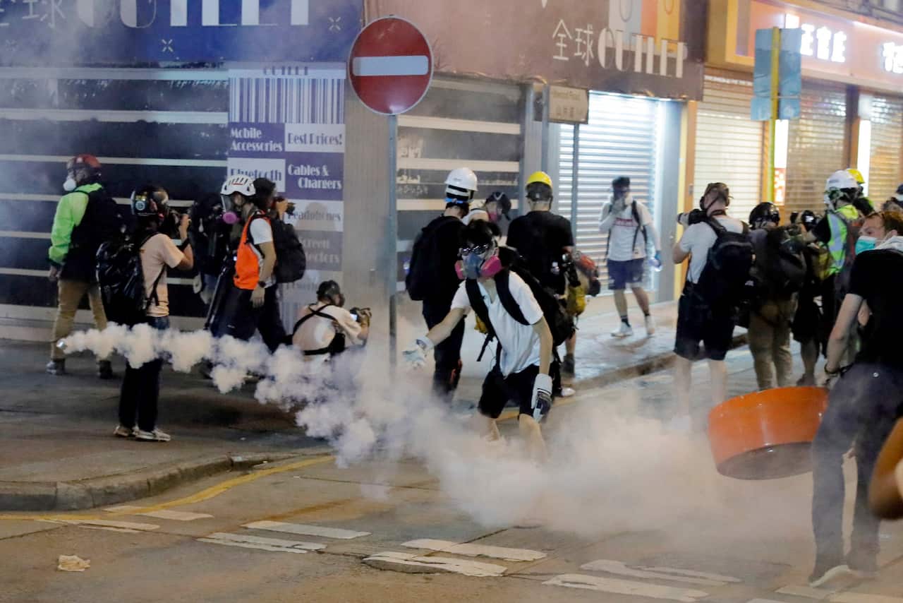 Protesters react to tear gas during a confrontation with police in Hong Kong