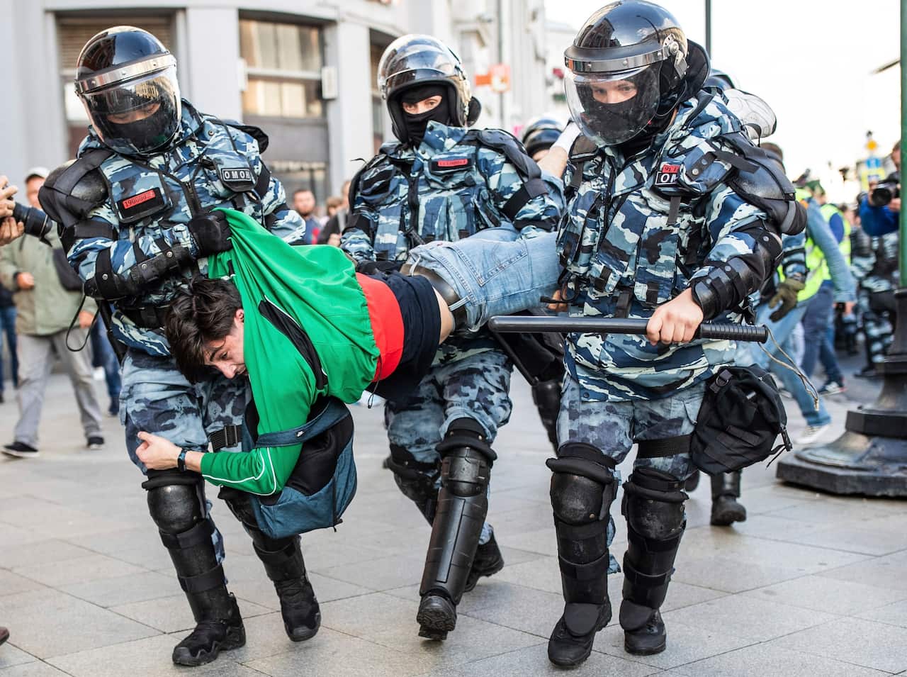 Police detain a man during a protest in Moscow, Russia