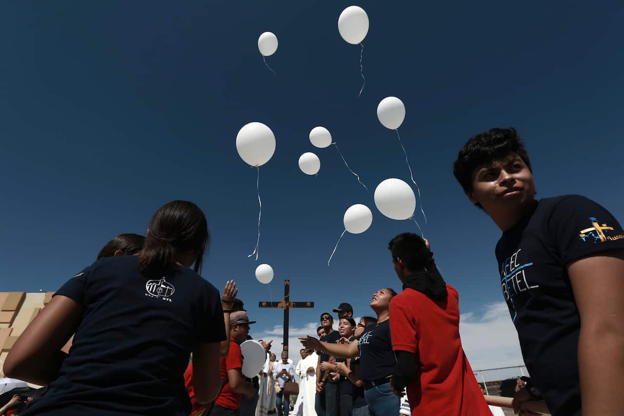 Faithful release balloons during a Mass for peace, in Ciudad Juarez, Mexico, Saturday, Aug. 10, 2019, marking the one week anniversary of a shooting that killed 22 at a Walmart in El Paso.