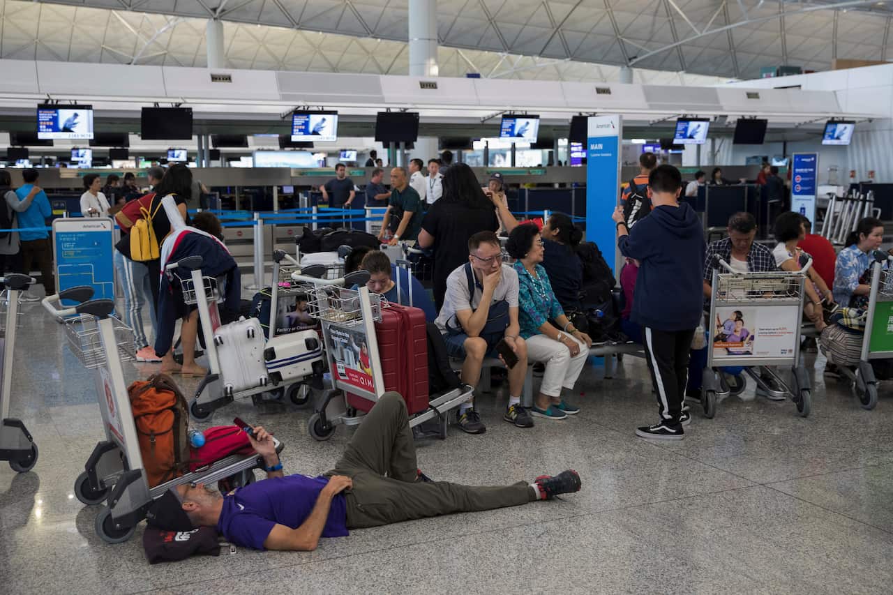 Stranded travelers wait in the departure hall of the Hong Kong International Airport in Hong Kong.
