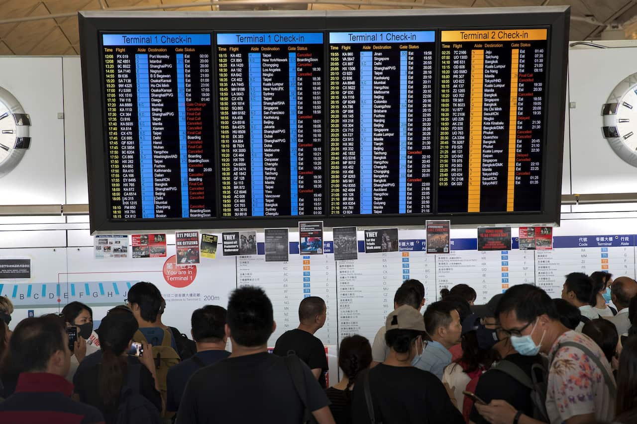 Stranded travelers check their flights information.