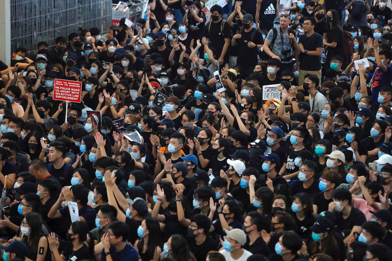Protesters stage a sit-in rally at Hong Kong's airport on Tuesday.