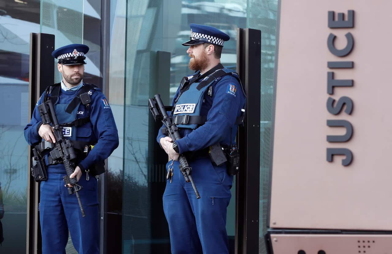 Armed police stand outside the Christchurch District Court.