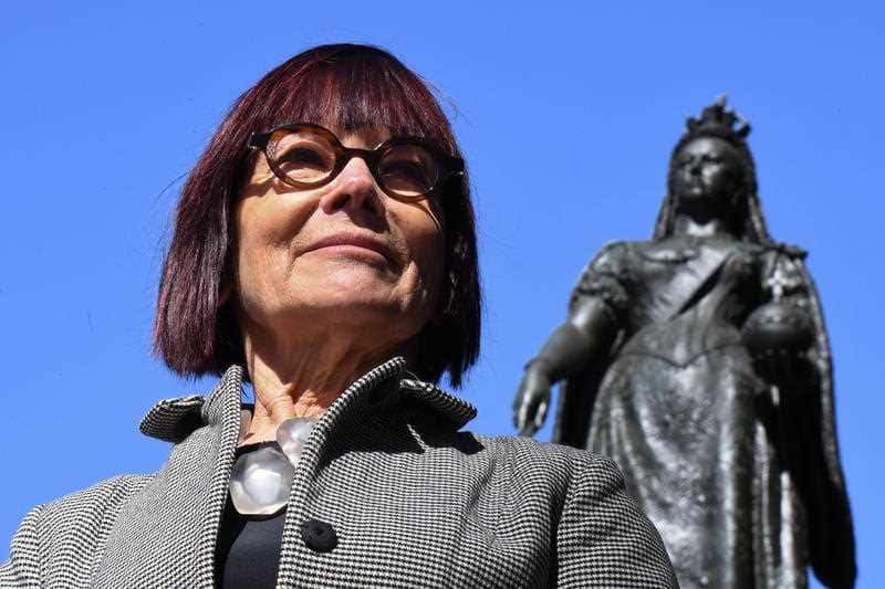 Professor Jenny Hocking poses for a photograph in front of a statue of Queen Victoria at Queen's Square in Sydney, Friday, August 16, 2019
