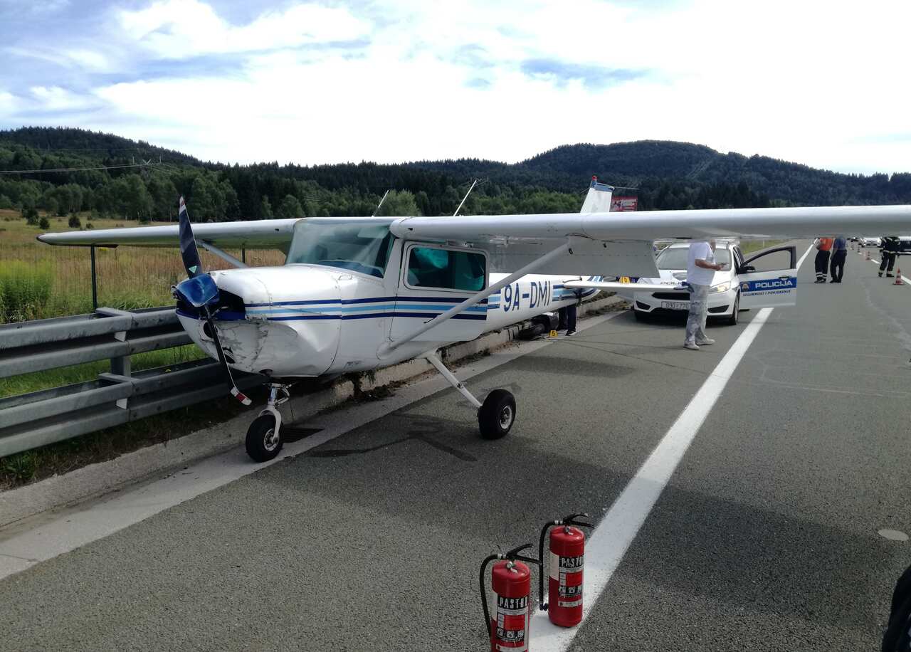 A small plane is parked after making an emergency landing on a main highway in Croatia.