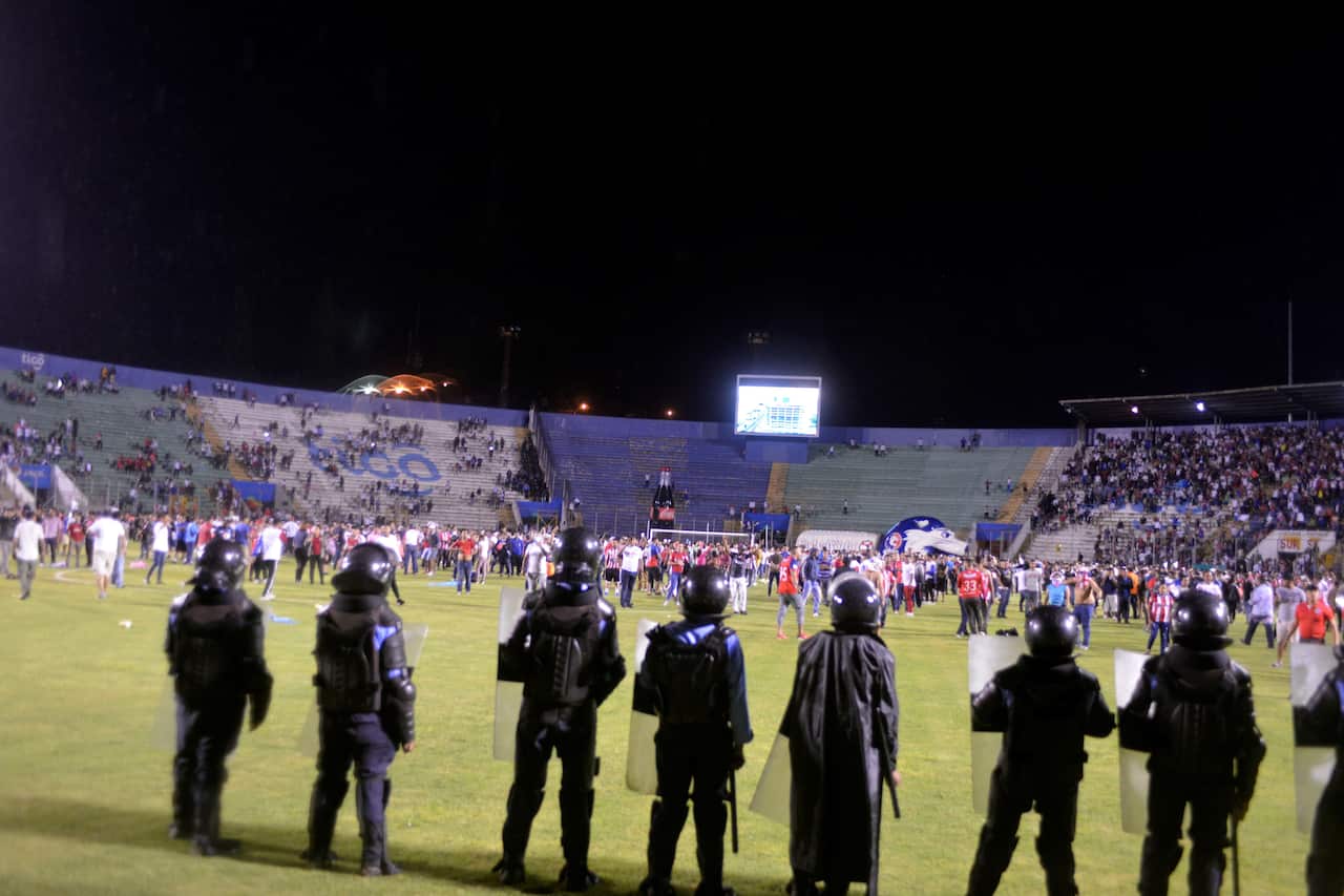 Supporters enter the field.