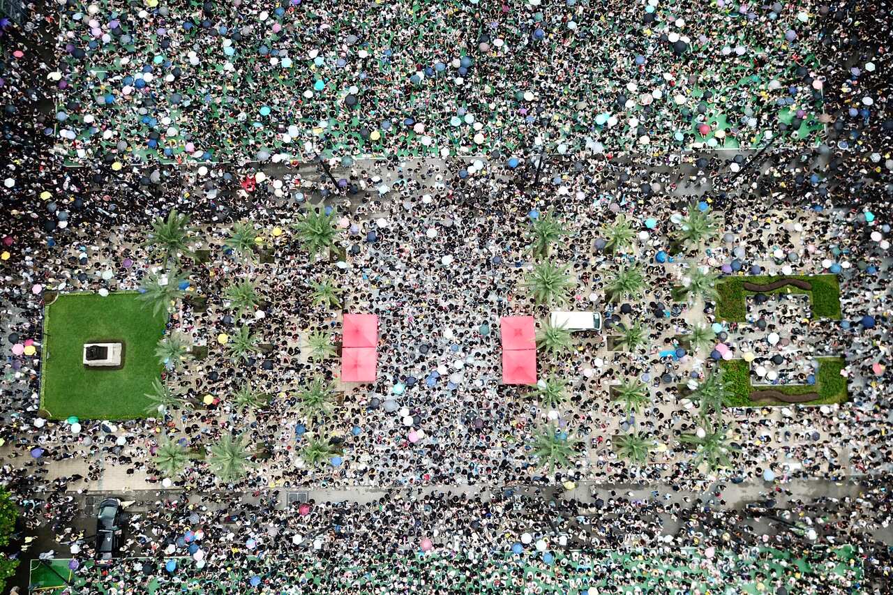 Protesters gather on Victoria Park in Hong Kong Sunday, Aug. 18, 2019. Thousands of people streamed into the park for what organizers hope will be a peaceful demonstration for democracy in the semi-autonomous Chinese territory. (AP Photo/Sunny Mok)