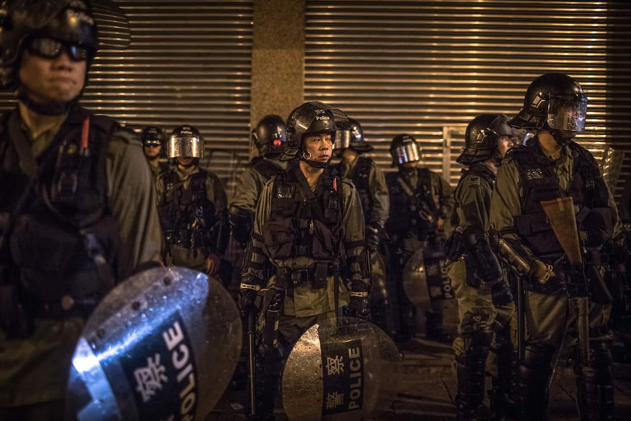 Riot police stand guard in Sai Ying Pun district during an anti-government rally in Hong Kong, China.