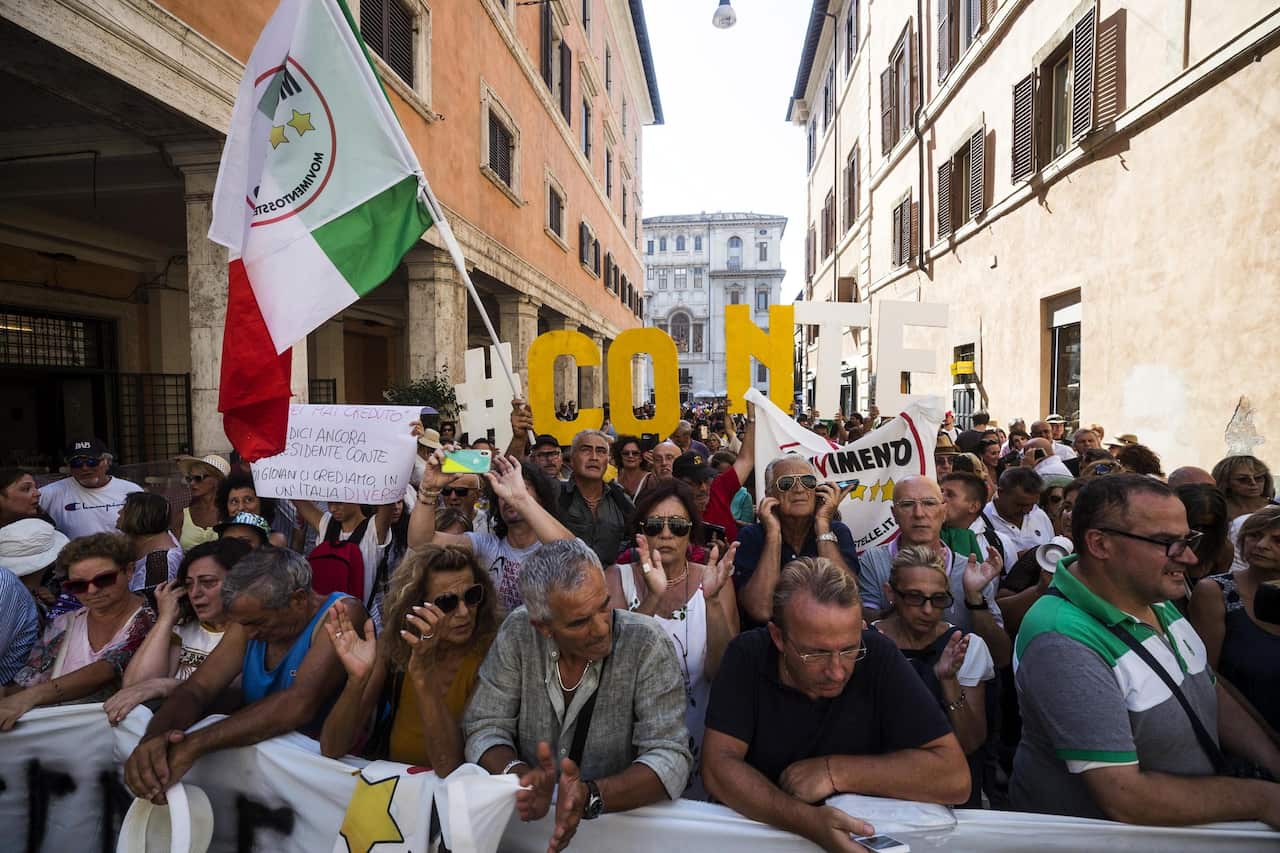 Supporters of the Five Star Movement (M5S) rally outside the Senate where Italian Prime Minister Conte is addressing the Parliament in Rome.