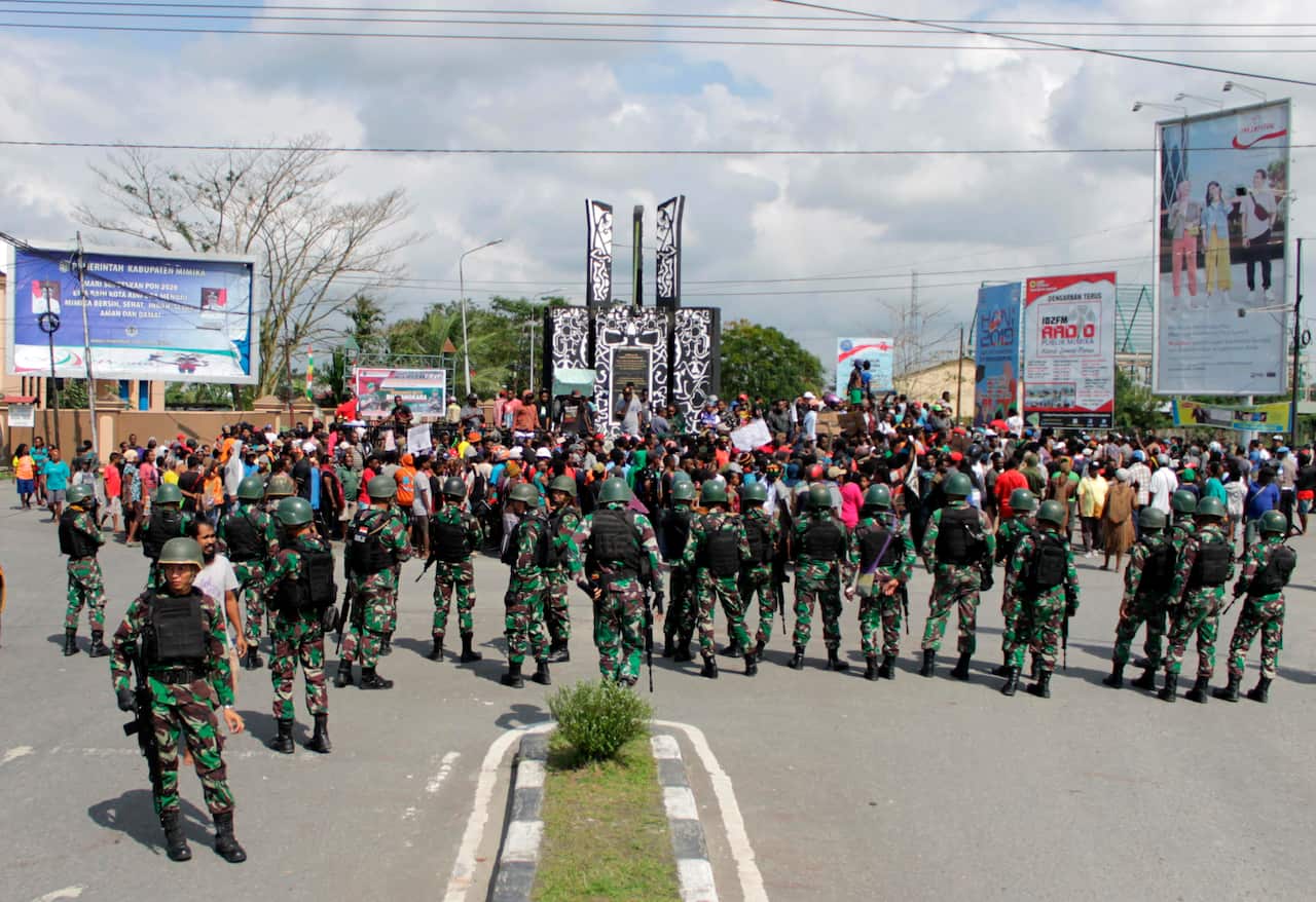 Indonesian soldiers stand guard during a protest in Timika.