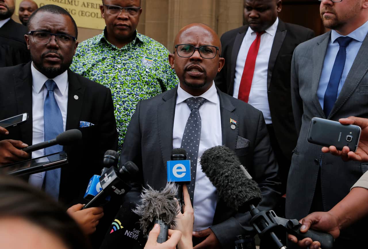 Nelson Mandela Foundation's CEO, Sello Hatang, speaks to the press on the steps of the Johannesburg High Court.