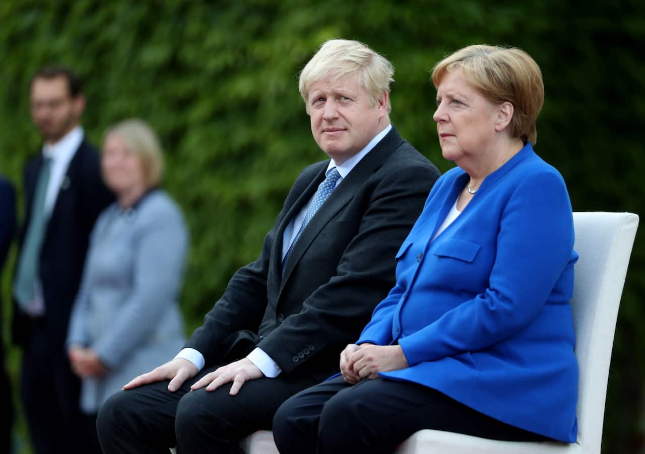 German Chancellor Angela Merkel receives British Prime Minister Boris Johnson with military honors at the Chancellery in Berlin.