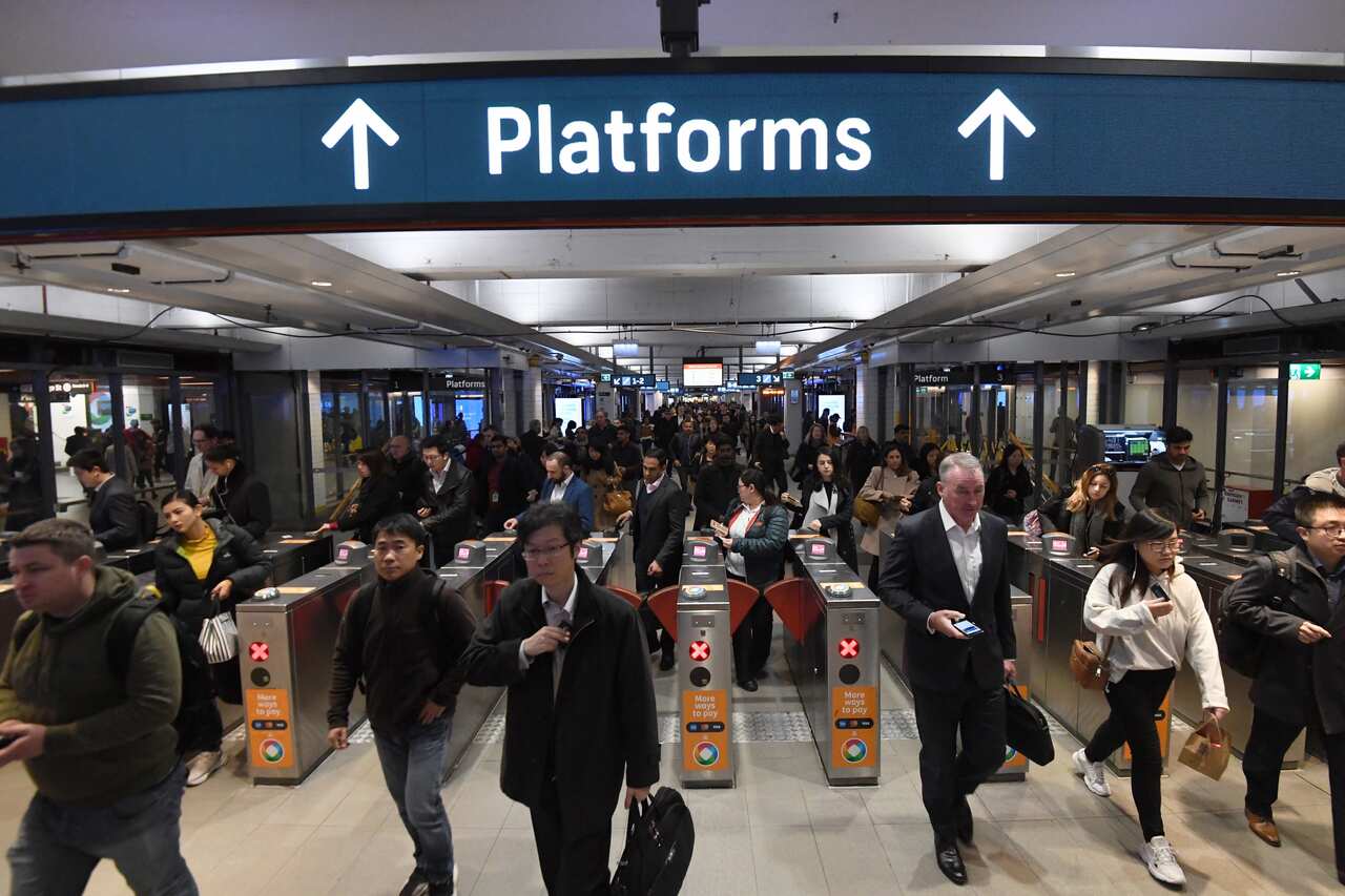 Commuters are seen at Town Hall train station in Sydney, Friday, August 23, 2019. A train breakdown at Town Hall station is causing delays on the network. (AAP Image/Peter Rae) NO ARCHIVING