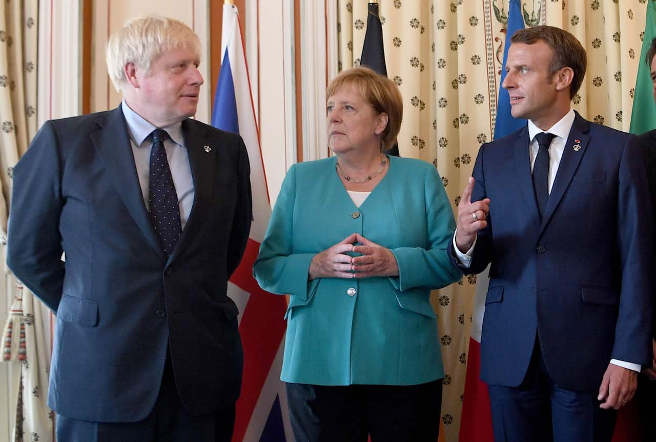 Boris Johnson (left) with German Chancellor Angela Merkel and French President Emmanuel Macron at the EU meeting during the G7 summit in France. 