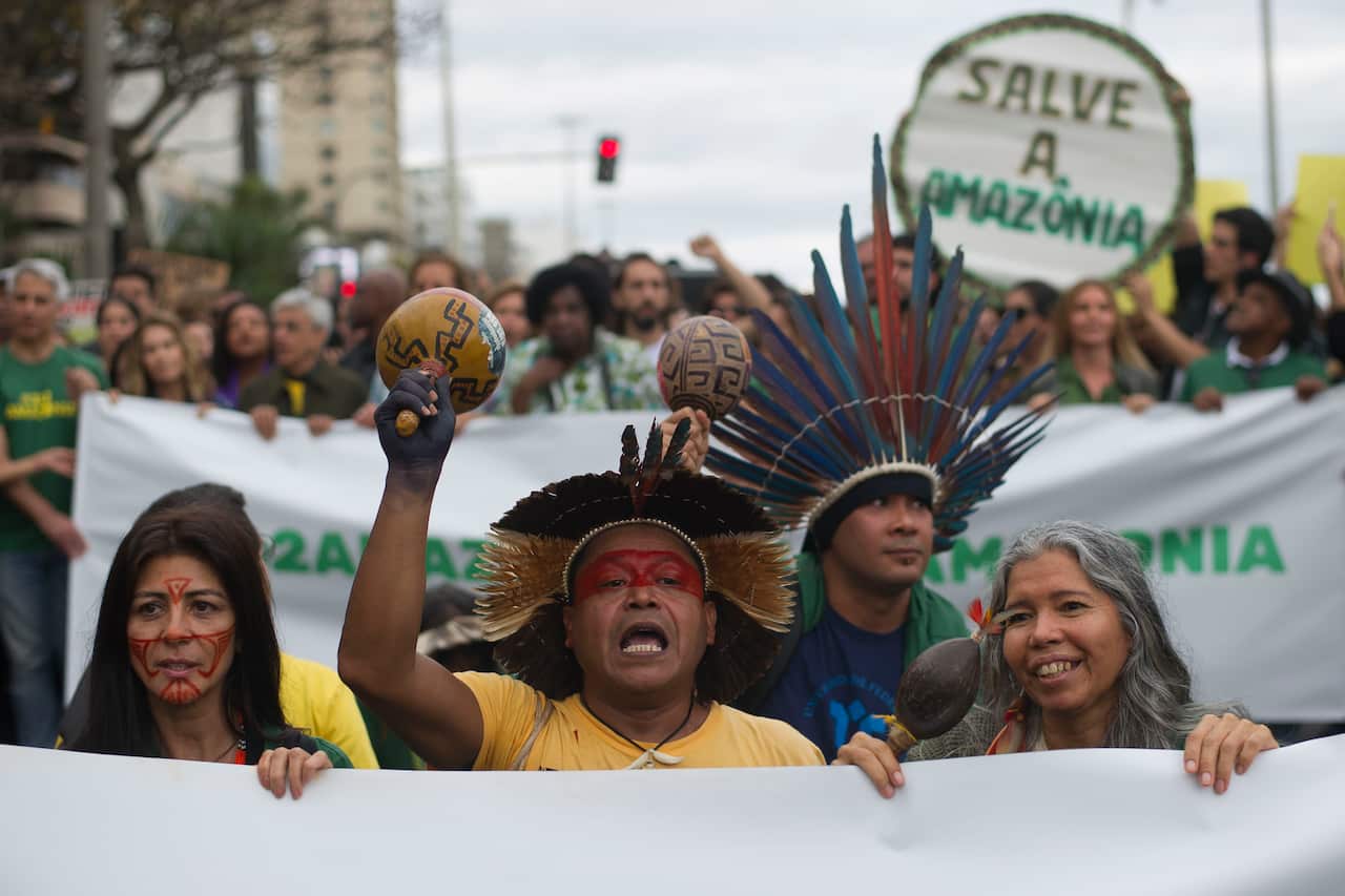 Indigenous people protest in defense of the Amazon while wildfires burn in the region.