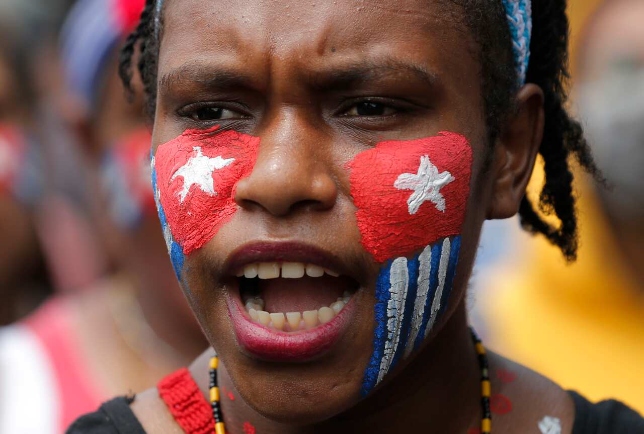 A Papuan student with her face painted with the colors of the separatist 'Morning Star' flag in Jakarta, Indonesia. 