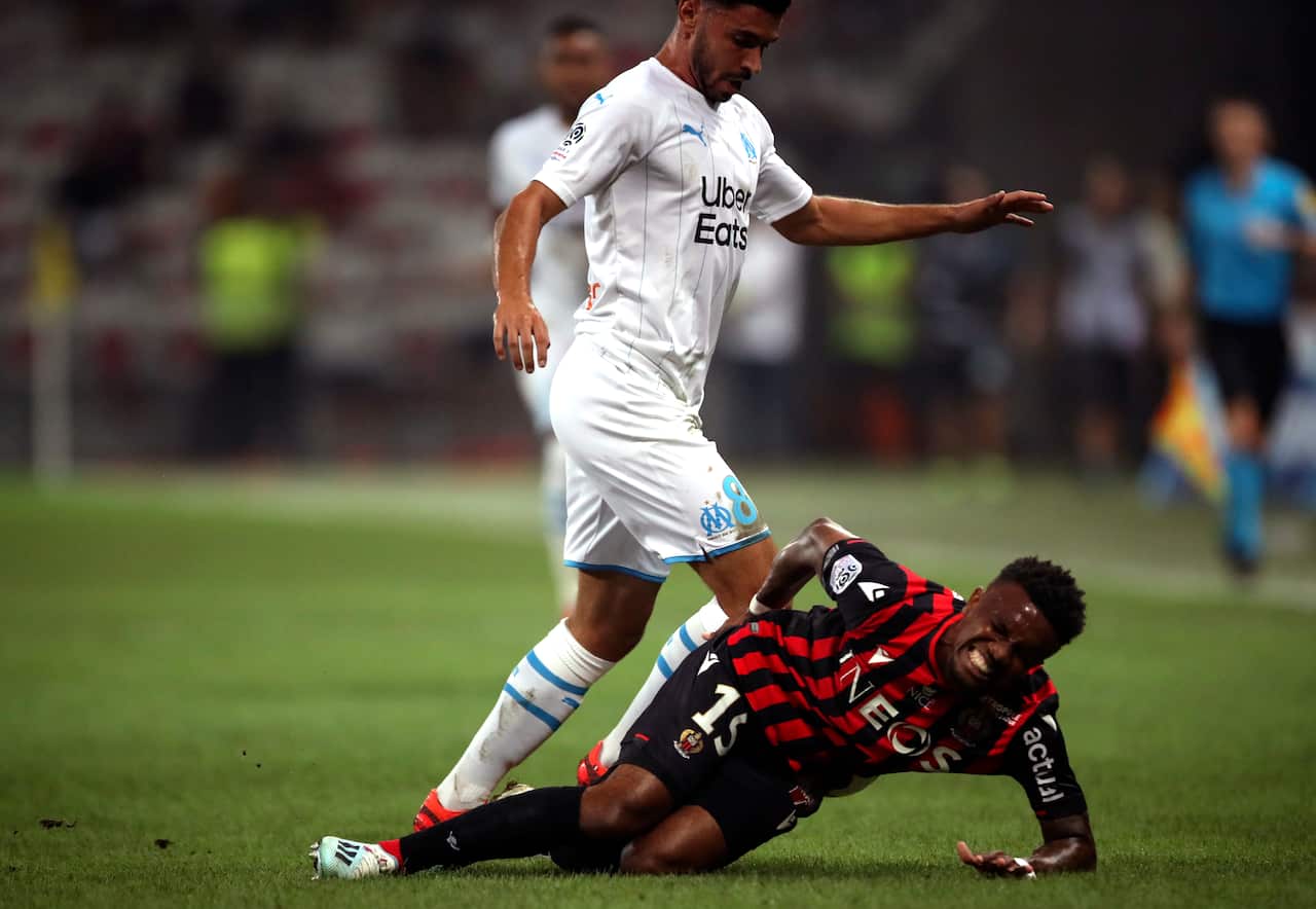 Nice's Patrick Burner, below, takes a tumble during the French League One soccer match between Nice and Marseille at the Allianz Riviera stadium in Nice, southern France. 