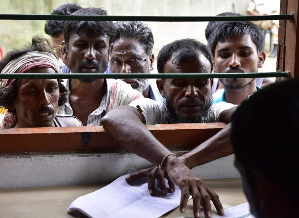 Villagers check their names in the published final list of National Register of Citizens (NRC) at NRC office in Morigaon, Assam, India