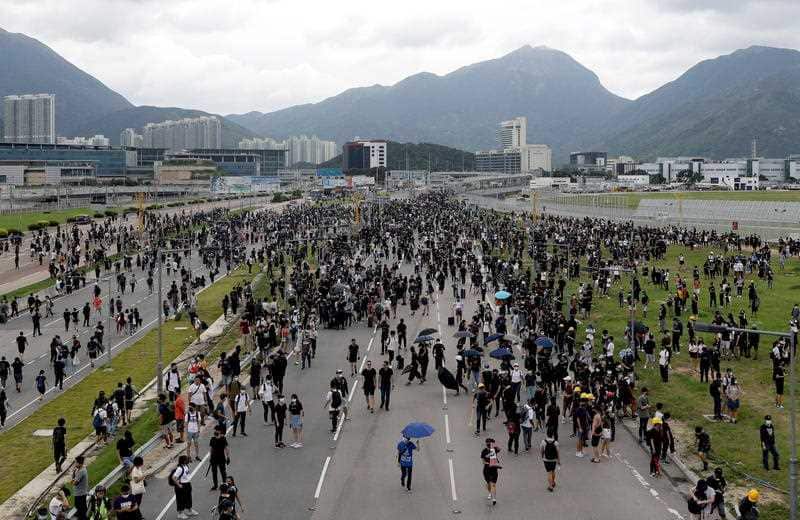Protesters block a road leading to the Hong Kong International Airport in Hong Kong