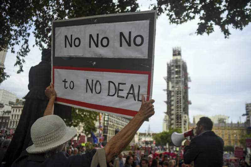 People take part to a demonstration against British Prime Minister Boris Johnson, in London, Monday, Sept. 2, 2019. 