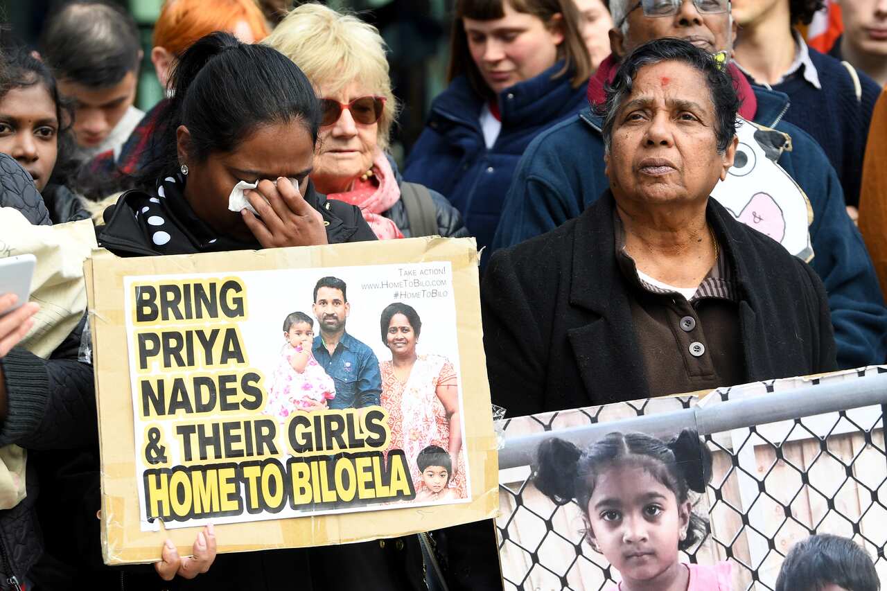 A supporter reacts during a vigil for the Tamil family awaiting a court decision.          