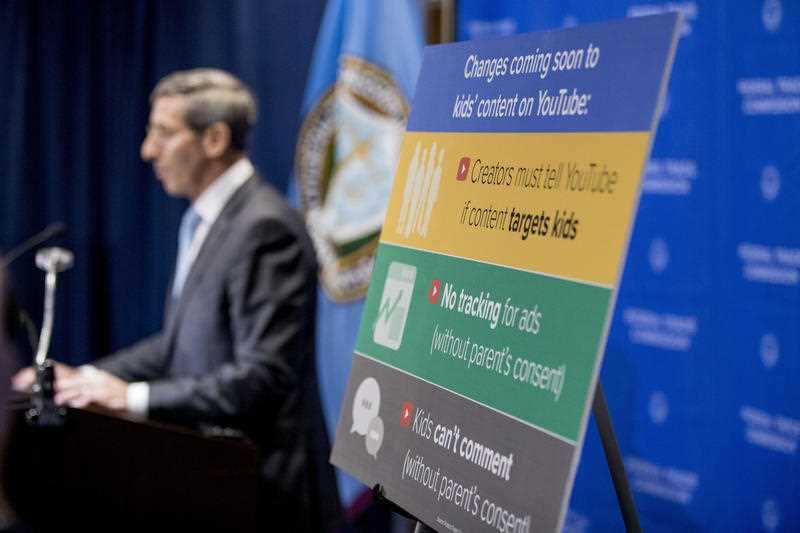 A sign with coming changes to kids' comment on YouTube is displayed as Federal Trade Commission Chairman Joe Simons speaks at a news conference