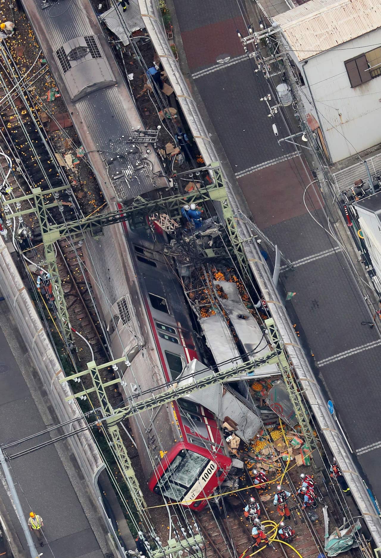 An aerial view shows authorities working at the scene of a train crash in Yokohama.