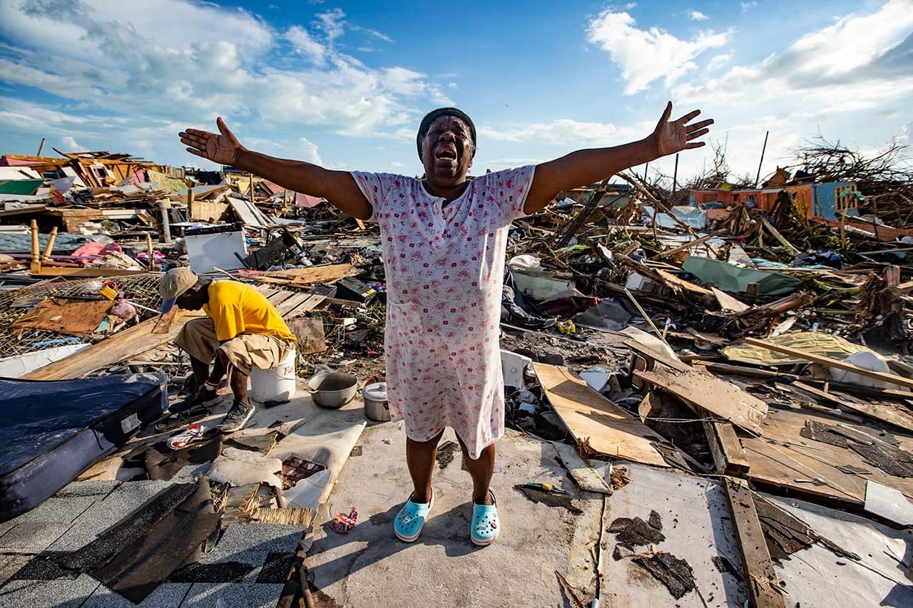 Aliana Alexis of Haiti stands on the concrete slab of what is left of her home in an area called "The Mud" at Marsh Harbour in Great Abaco Island, Bahamas.