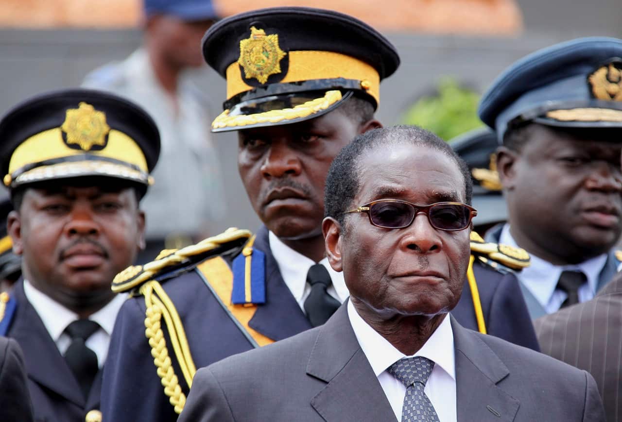 Robert Mugabe arrives for the burial of a prominent member of his party in 2009.