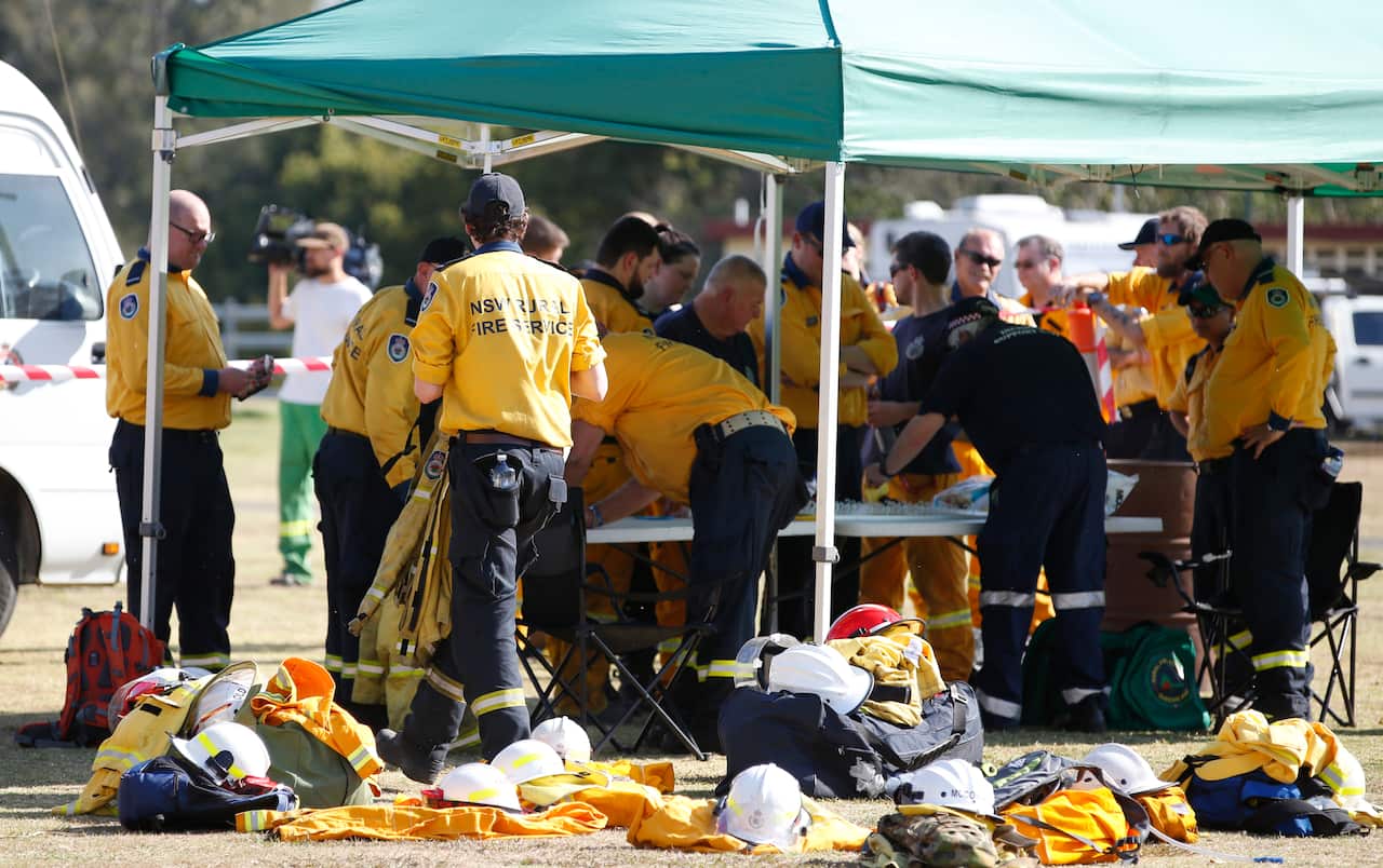 Fire and Emergency crews from NSW prepare to join their Queensland counterparts in the ongoing bushfire control effort near the rural town of Canungra.