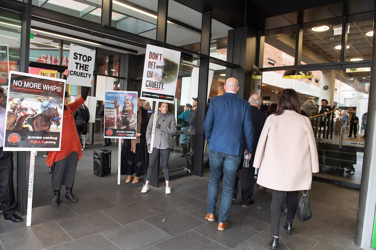 Anti-racing protestors rally outside the Jam Factory in South Yarra before the premiere of the movie Ride Like a Girl.