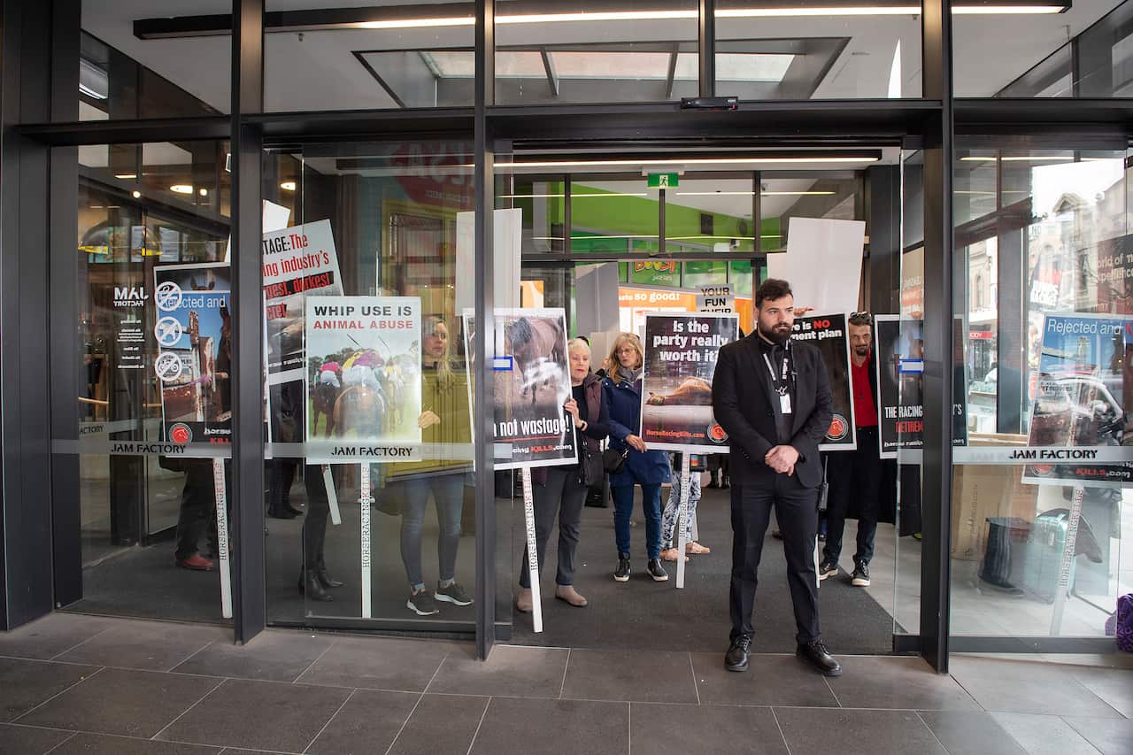 Anti-racing protestors rally outside the Jam Factory in South Yarra before the premiere of the movie Ride Like a Girl.