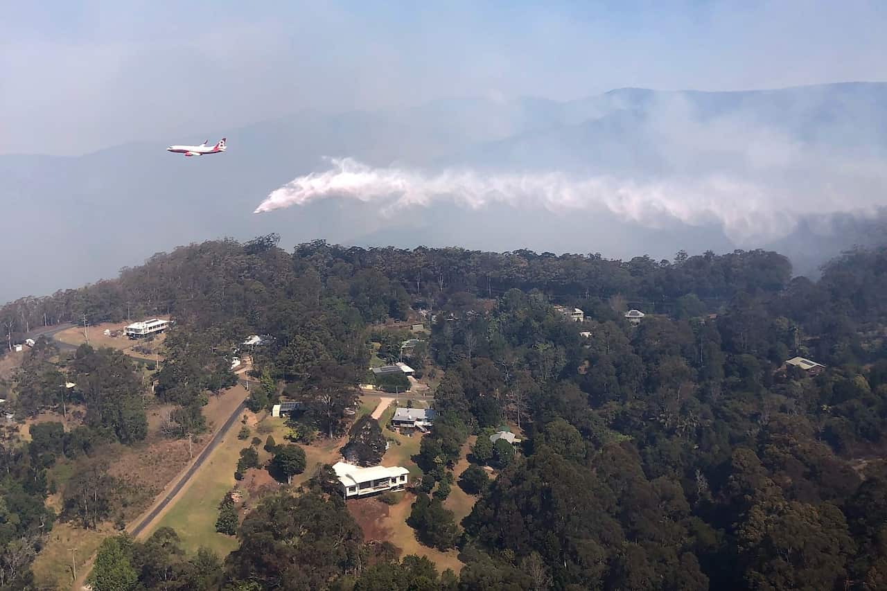 Queensland Fire and Emergency Services (QFES) Large Air Tanker (LAT) dropping 15,000L of water over bushfires in Binna Burra, Queensland.