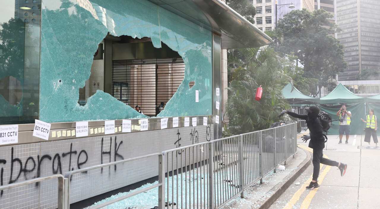 Protesters break the gateway of Mass Transit Railway (MTR) in Hong Kong.