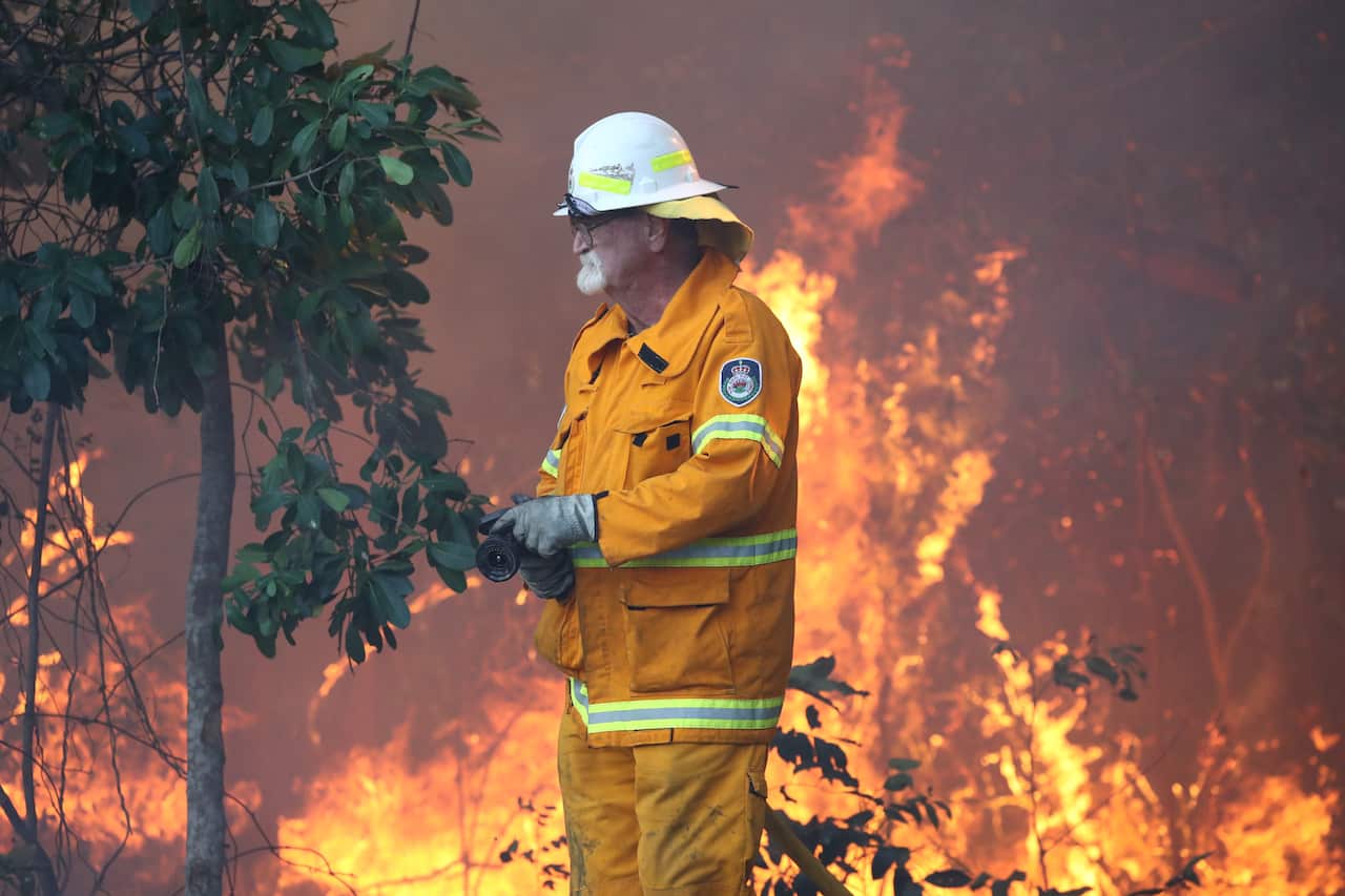 Firefighters  battle bushfires in Angourie, in northern New South Wales on Tuesday. 
