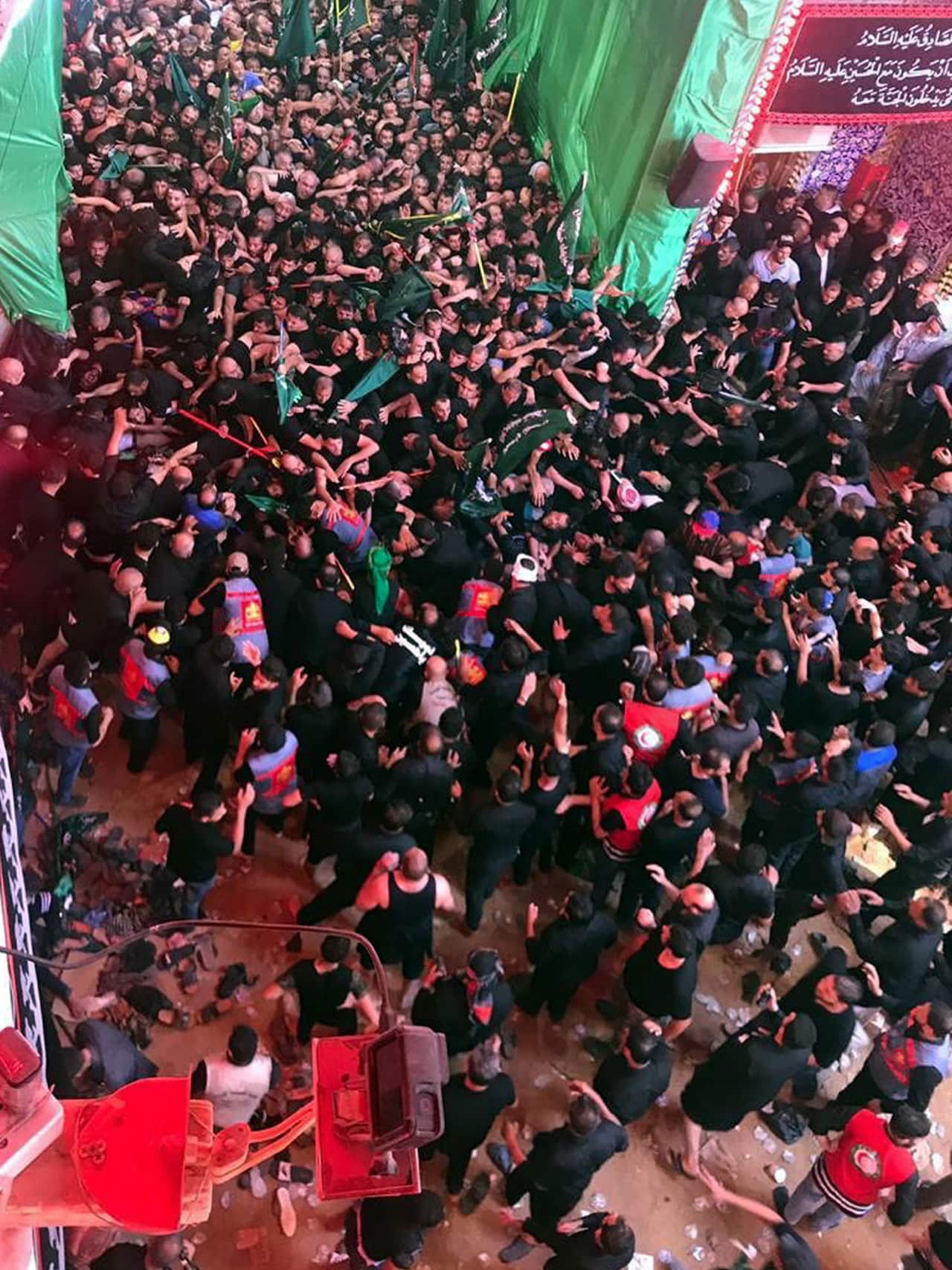 Iraqi Shiite worshipers gather next to the site of a stampede accident inside Imam Hussain shrine, in the holy city of Karbala, southern Iraq