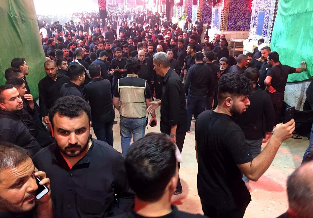Iraqi Shiite worshipers gather next to the site of a stampede accident inside Imam Hussain shrine, in the holy city of Karbala, southern Iraq
