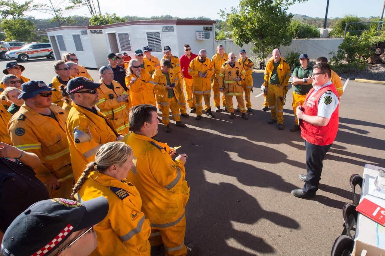 A fresh team of firefighters from Brisbane and surrounding areas arrive to relieve exhausted local firefighters at Peregian Beach.