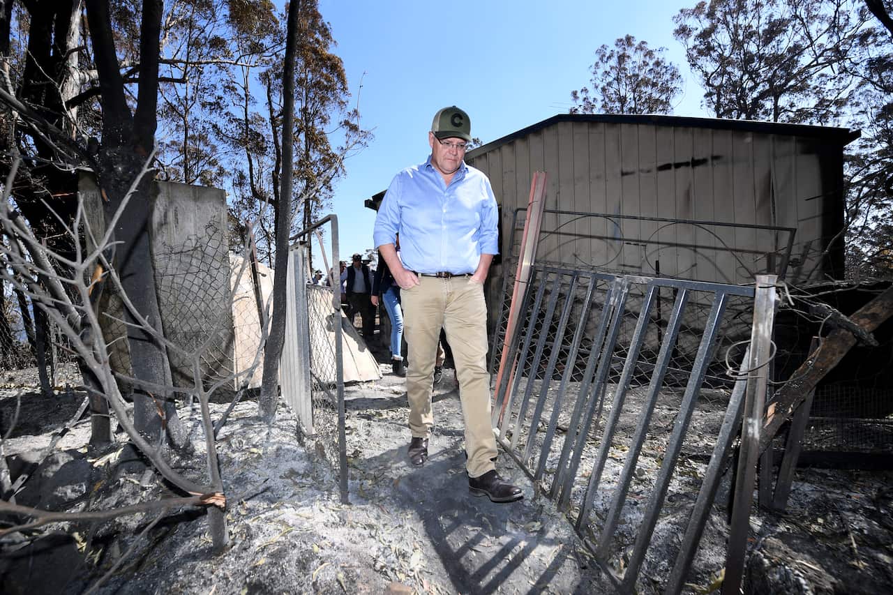 Prime Minister Scott Morrison inspects a burnt-out property at Binna Burra.